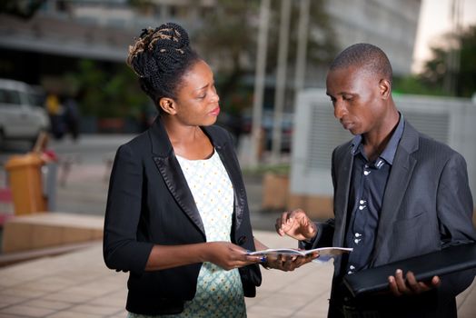 business people standing in the street are exchanging information and working together on a project