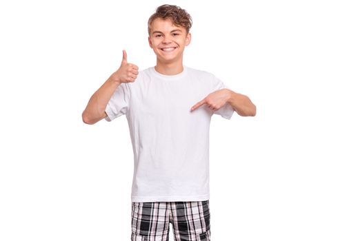 Cute teen boy pointing up, gesturing idea or doing number one gesture, isolated on white background