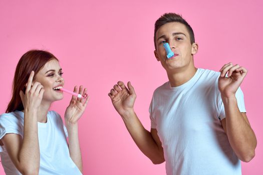 pregnant mom and happy father on pink background Young family waiting for baby. High quality photo