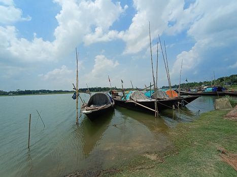 black colored wooden boat on river with sky