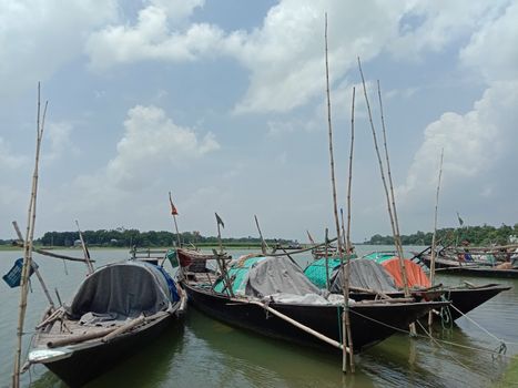black colored wooden boat on river with sky