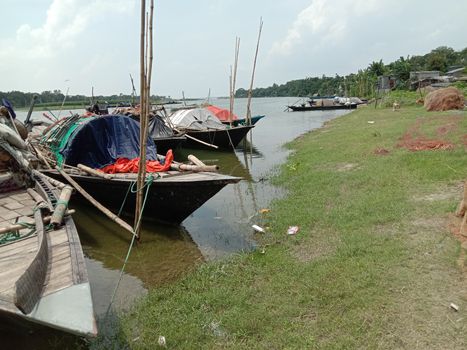black colored wooden boat on river with sky