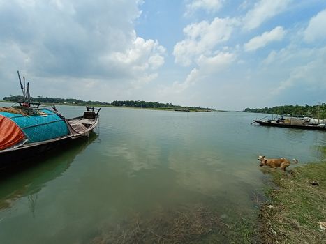 black colored wooden boat on river with sky