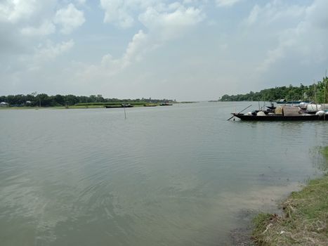 black colored wooden boat on river with sky