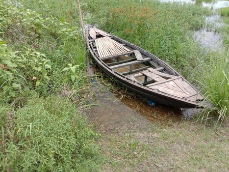 black colored wooden boat on lake