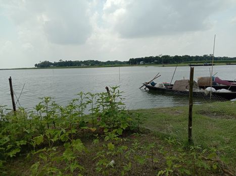 black colored wooden boat on river with nature