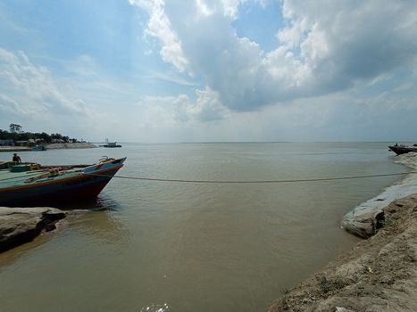 black colored wooden boat on river with sky