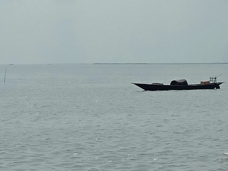 black colored wooden fishing boat on river