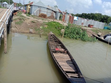 black colored wooden fishing boat on lake