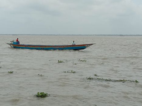 wooden fishing boat on river with sky
