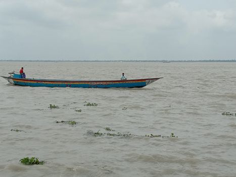 wooden fishing boat on river with sky
