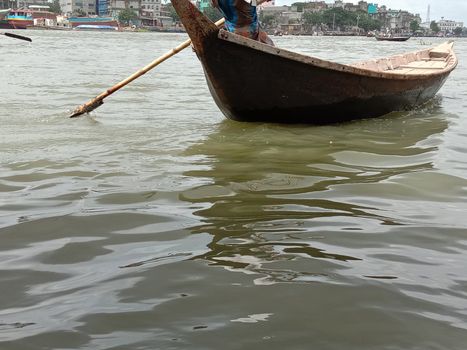 black colored wooden fishing boat on river
