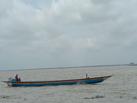 wooden fishing boat on river with sky