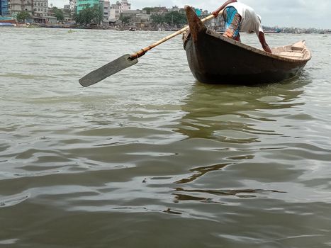 black colored wooden fishing boat on river
