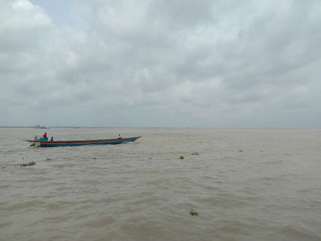 wooden fishing boat on river with sky