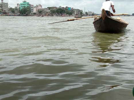 black colored wooden fishing boat on river