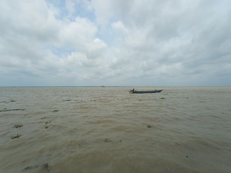wooden fishing boat on river with sky