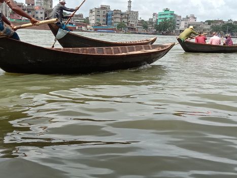black colored wooden fishing boat on river