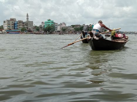black colored wooden fishing boat on river