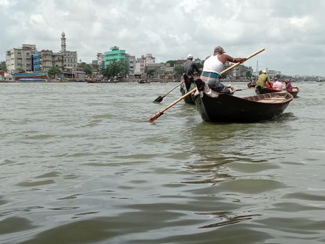 black colored wooden fishing boat on river
