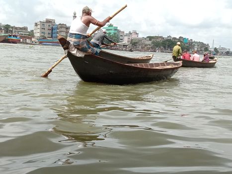 black colored wooden fishing boat on river