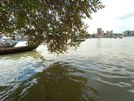 black colored wooden fishing boat on river
