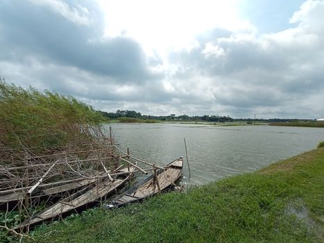 black colored wooden fishing boat on lake