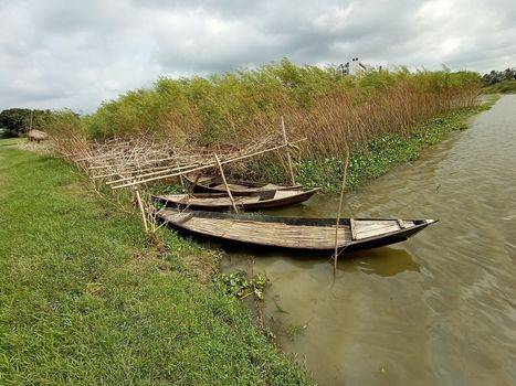 black colored wooden fishing boat on lake