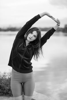 Brunette girl doing sports exercises in the morning