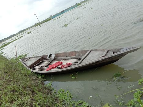 black colored wooden fishing boat on lake