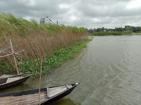 black colored wooden fishing boat on lake