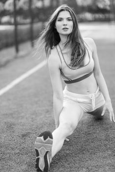 Brunette girl doing sports exercises in the morning