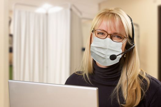 Woman At Medical Office Desk Wearing Face Mask.