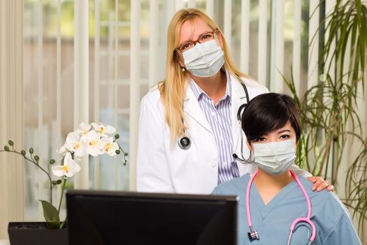 Doctor and Nurse At Office Desk Wearing Medical Face Masks.