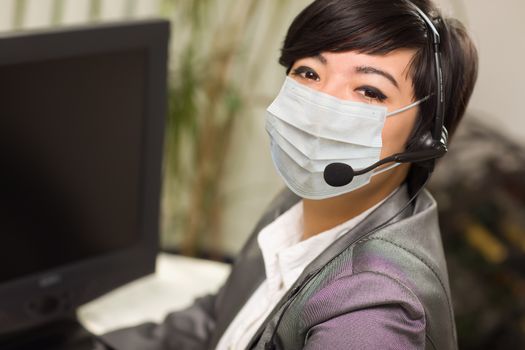 Woman At Office Desk Wearing Medical Face Mask.