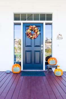 Beautiful House Porch Decorated For Halloween with Pumpkins Wearing Medical Face Masks.