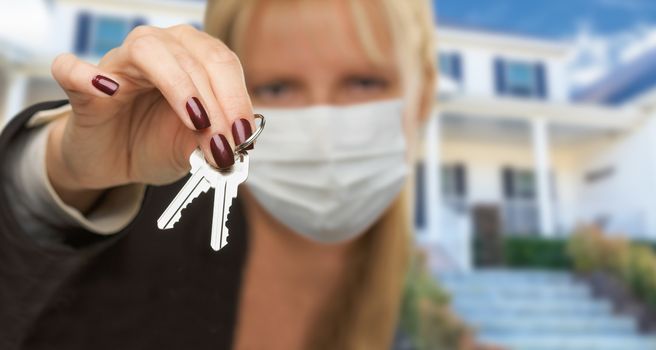 Woman Presenting House Keys Wearing Medical Face Mask.