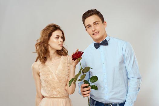 Young couple hugs romance dating lifestyle relationship light background red rose. High quality photo