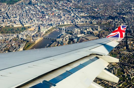 View from a commercial flight passing over London city centre while descending to the airport
