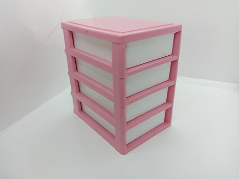 pink and white colored plastic toy wardrobe