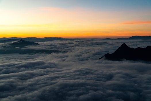 sunrise and sea of fog view on phu chi fa mountain area and national forest park in chiang rai, Thailand.