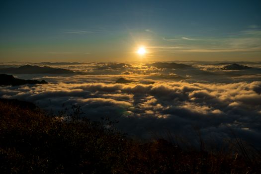 sunrise and sea of fog view on phu chi fa mountain area and national forest park in chiang rai, Thailand.