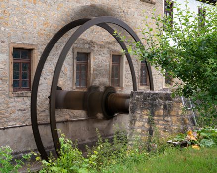 Close up image of mill wheel in motion, old watermill of Bad Sobernheim, Germany