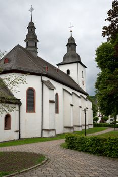 View along a footpath to the parish church of the Sauerland village Oberkirchen, Schmallenberg, Germany