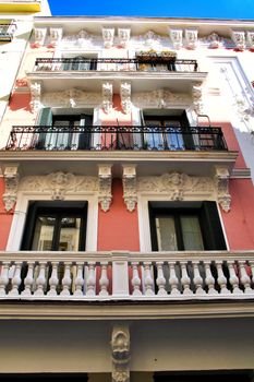 Old colorful and beautiful facades with vintage streetlight in Madrid streets in Spring. 