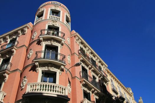 Old colorful and beautiful facades with vintage streetlight in Madrid streets in Spring.