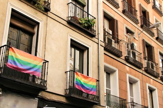 Facade with gay pride flag on its balconies in Chueca, Madrid
