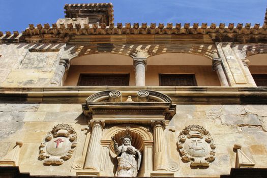 Old stone carved facade of El Salvador Church in spring in Caravaca de la Cruz, Murcia, Spain