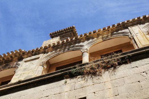 Old stone carved facade of El Salvador Church in spring in Caravaca de la Cruz, Murcia, Spain