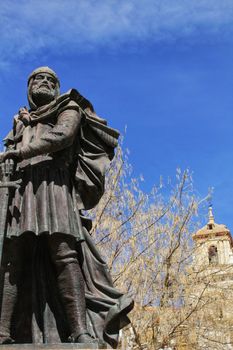 Christian soldier monument in Caravaca de La Cruz square, Murcia, Spain. El Salvador bell tower church in the background.